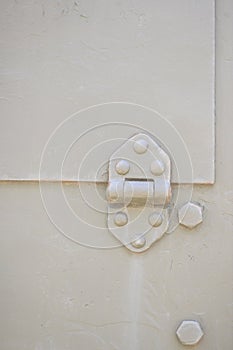 Detail of an old surface with exfoliated paint and rivets on military equipment. Military background