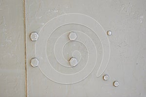 Detail of an old surface with exfoliated paint and rivets on military equipment. Military background