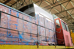 Detail of old traction locomotive on serviced at a repair depot photo