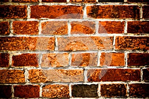 Detail of old and weathered grungy brown and red brick wall surface texture background