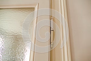 Detail of an old white door hinge