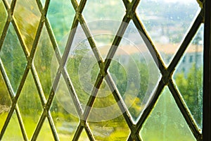 Detail of an old window with handmade leaded glass