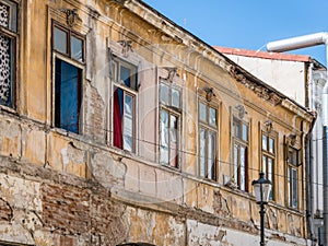 Detail with an old worn out building. Old vintage architecture in Bucharest, Romania