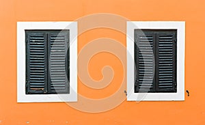 Detail of olf wooden window with closed shutters.