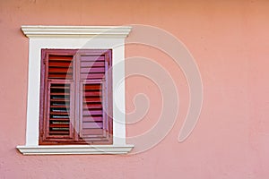 Detail of olf wooden window with closed shutters.