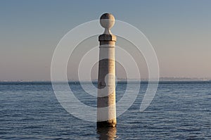 Detail of one of the columns at the Cais das Colunas and the Tagus River in the city of Lisbon