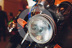 Detail on one of the LED headlights of a motorcycle.