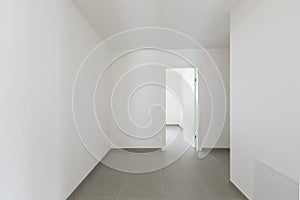 Detail of open doors in all-white apartment