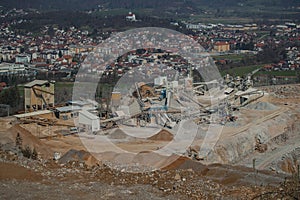 Detail of an open mine or quarry on a sunny day at Verd, Slovenia. Visible terraces and vast surface of sand and stones, with a photo
