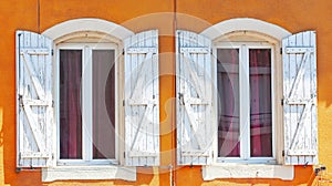 Detail of an open wooden vintage rustic windows on red cement old wall can be used for background