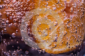 Detail of orange slice in sparkling water.