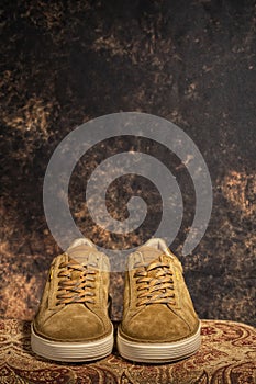 Detail of a pair of high-end brown casual sneakers with the background out of focus