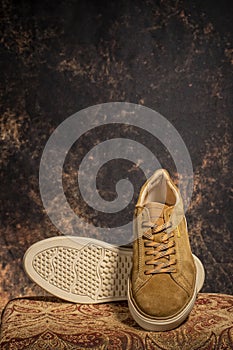 Detail of a pair of high-end brown casual sneakers with the background out of focus