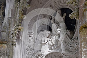 Detail in the park - old stone statue with angels, Quinta da Regaleira in Sintra