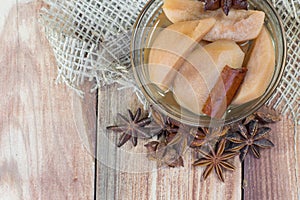 Detail on a Pear Compote on Wooden Table with Star Anise