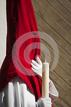 Detail penitent white holding a candle during Holy Week photo