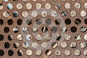 Detail of perforated and rusty metal, rusty and leaky metal plate, metal corroded texture