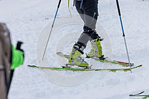Detail of a person performing a 180 degree turn while ski touring or mountaineering. Person making a turn on skis walking uphill