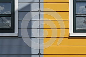 Detail photo of grey and yellow painted houses
