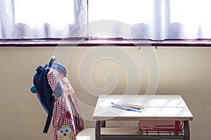 Detail photo of a primary school classroom where you can see the place of study and the typical material of a child student.The