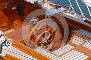 Detail photos of a sailing yacht, steering wheel, teak deck and compass