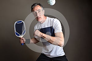 Detail of pickleball player going to hit a ball isolated