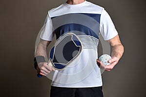 Detail of pickleball player with racket and ball isolated background