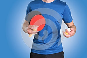 Detail of ping-pong player rackets and balls in hands on blue