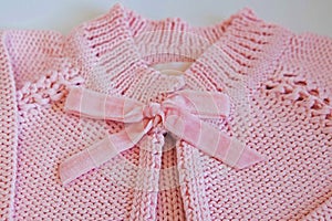 Detail of pink baby blouse made of tricot