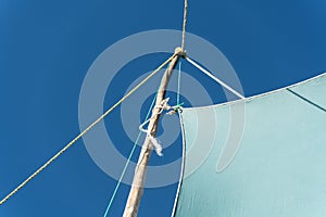 Detail on pirogue - small boat used in Madagascar - mainsail jib blea sky in background