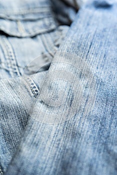 Detail of the pocket of a blue denim jeans. Blue denim jacket