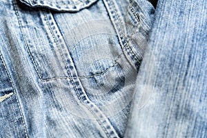 Detail of the pocket of a blue denim jeans. Blue denim jacket