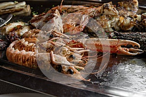 Detail of prawns in tray with mixed grilled fish