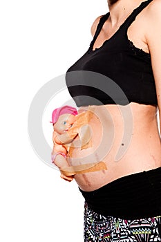 Detail of pregnant belly with doll