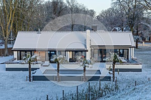 Detail of Private solar panels with snow on a detached bungalow family house