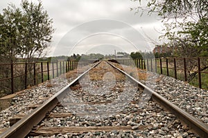 Detail of the rails of the tracks of a train that are lost in the infinity surrounded by boulders. Concept trains, tracks,