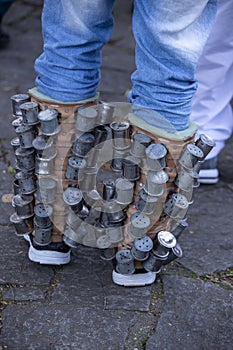 Detail of rattles on the legs of a group of revelers, rehearsing for the Congada photo
