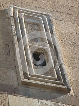 Window with inside a pigeon in the mosque of Alladin to Konya in Turkey.
