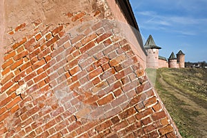 Detail of red bricks wall and towers of Saint Euthymius monastery in Suzdal, Russian heritage architecture