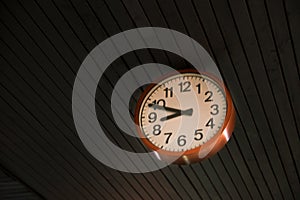 Detail of a red round wall clock on roof