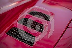 Detail of red super-sport car vents on a bonnet