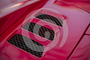Detail of red super-sport car vents on a bonnet photo