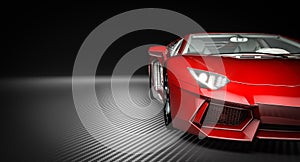 Detail of a red supercar on a carbon fiber background