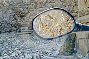 Detail of the reflections in a rearview mirror of a motorcycle