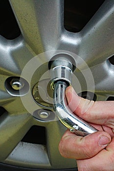 Detail of removing alloy wheel disc with telescopic lug wrench