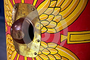 Detail of a reproduction Roman scutum shield with red and yellow photo