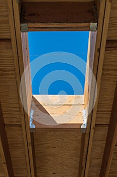 Detail of residential roof construction with framing for skylight, interior roof joists