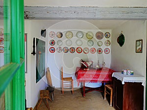 Detail from a retro nineteen century farm house, table, chairs red tablecloth