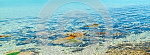 Detail of rocks and clear water in Le Bombarde beach