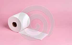 roll of white toilet paper  slightly unrolled  on a plain pink background